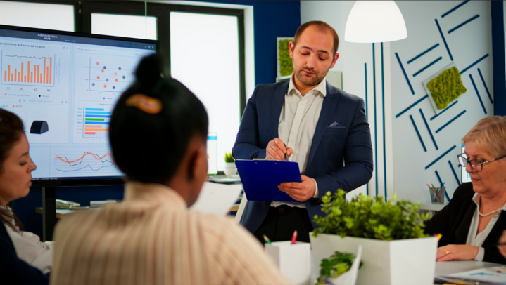 Business leader presenting company strategy how to find the perfect sales consultant to diverse team using digital whiteboard